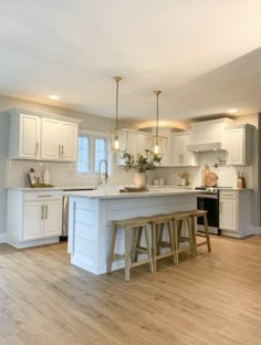 an image of a kitchen with white cabinets and counter tops on instagram for suzanna's post