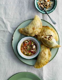 two plates with pastries and a bowl of salsa