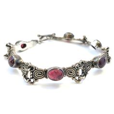 Vintage Estate Garnet Gemstone Sterling Silver Bracelet. Oval Garnet Cabochon Gemstones With A Captivating Red Purple Cranberry Color. Spiral Coil Pattern Frames Each Side Of The Gemstones. Love The Handcrafted Workmanship And Unique Design Of This Vintage Piece! Acid Tests For Sterling Silver (No Stamp Due To Handmade Origins). 7.75” Length And 0.25” Width. Excellent Vintage Condition With Natural Patina Throughout. Vintage Garnet Jewelry, Glam Jewelry, Aesthetic Accessories, Silver Link Bracelet, Diy Jewelry Inspiration, Cranberry Color, Sterling Silver Bangle, Garnet Jewelry, Pretty Jewelry