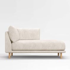 a white couch sitting on top of a wooden frame