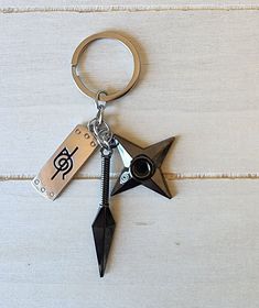 a metal keychain with a musical note on it and a black pointed star