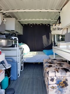 the inside of a camper with mattresses and storage