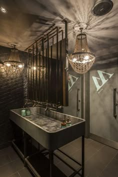 an instagramted photo of a bathroom with a sink and chandelier hanging from the ceiling