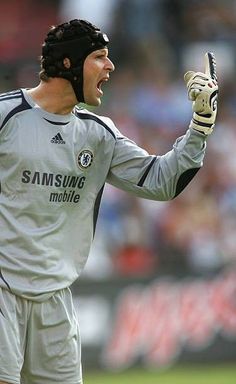 a soccer player with his mouth open holding a glove