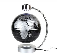 a black and white photo of the earth on a table lamp with an outlet plugged into it