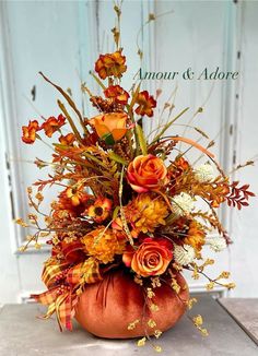 a vase filled with lots of flowers on top of a table