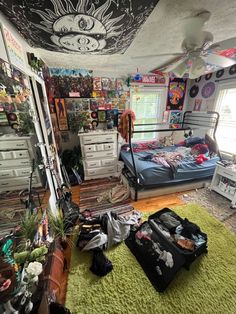 a bedroom with lots of clutter on the floor