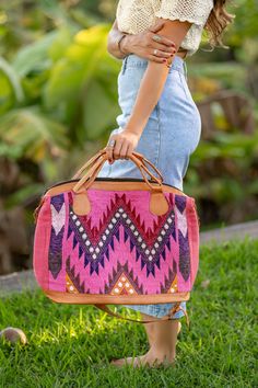 Big pink and black Mexican textile western leather boho duffle bag. This ethnic bohemian bag is the perfect large size bag. Great as a travel size carry on or overnight duffle bag,  One-of-a-kind and handmade in Mexico. This large statement bag is handmade with traditional Mexican textile. Made with 100% cotton combined with a light tan color 100% genuine leather.  This bag measures approximately 22 inches wide by 14.5 inches deep. The base of the bag measures approximately 7.5 inches wide by 17 Bohemian Large Capacity Rectangular Satchel, Pink Tote Bag For Trips, Bohemian Travel Tote Bag, Bohemian Pink Satchel Bag, Bohemian Style Travel Tote Bag, Bohemian Multicolor Travel Satchel, Bohemian Tote Shoulder Bag For Weekend Trips, Pink Bohemian Hobo Bag With Adjustable Strap, Bohemian Satchel With Top Carry Handle