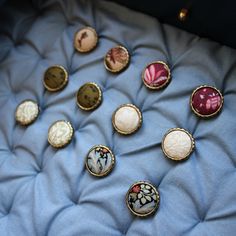 a bunch of buttons sitting on top of a blue blanket