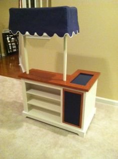 a table with an umbrella on top of it in the middle of a living room