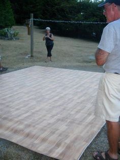 an older man standing on top of a wooden floor