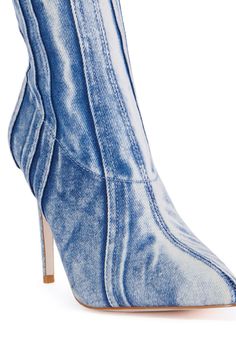 You can’t go wrong with The AZALEA WANG Herta Denim Bootie. This trendy boot features an acid wash denim textile upper, seam detailing throughout, a rounded ankle high shaft, a pointed toe silhouette, a slim stiletto heel, and a textured outsole for ultimate grip. Complete with a tonal inner ankle zipper closure and faux silver metallic hardware. Style with a mini jean skirt and vest for a whimsy, denim moment. (all measurements are approximate from size 7.5) - Denim Textile Upper - Pointed Toe - Stiletto Heel - Ankle High Shaft - 4” Heel Height - 6.75” Shaft Height - 11” Shaft Opening Circumference - Imported Product ID: 401970 Skirt And Vest, Mini Jean Skirt, Azalea Wang, Trendy Boots, Acid Wash Denim, Jean Skirt, Acid Wash, Stiletto Heel, Stiletto Heels