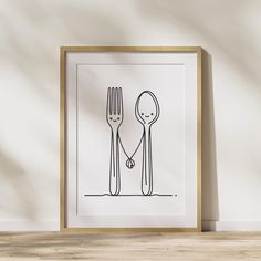 a black and white drawing of two forks and a spoon on a table next to a wall