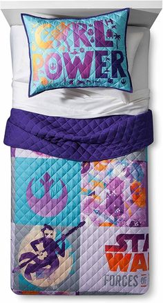 a bed with purple and blue comforters on it