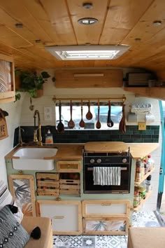 the interior of a small kitchen with wooden cabinets and counter tops, as well as utensils