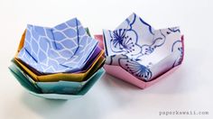 three paper bowls are stacked on top of each other, one is blue and the other is pink