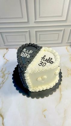 two heart shaped cakes sitting on top of a marble counter next to a white door