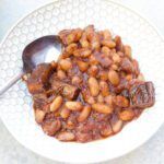 a white bowl filled with beans on top of a table