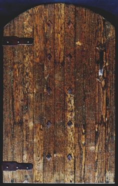 an old wooden door with holes in it