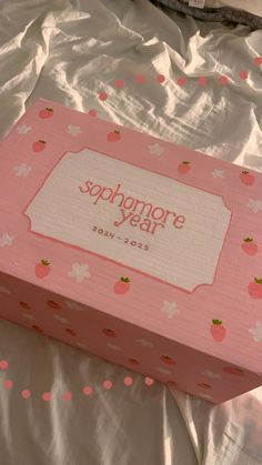 a pink box sitting on top of a bed