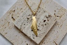 Show your love for Palestine with this stainless steel 18k gold plated Map of Palestine Pendant necklace. Beautifully engraved with the Arabic word فلسطين (Falasteen), which directly translates to "Palestine," this necklace is a powerful symbol of pride and heritage. Wear this elegant piece close to your heart and let it be a daily reminder of your connection to the rich history and enduring spirit of Palestine. Product Features 💫 Material: Stainless Steel, 18k Gold Plated Color: Luxurious Gold Pendant Length: 4cm To be worn with love and confidence, making a statement of pride and solidarity. Gold Map, Daily Reminder, Gold Pendant, Favorite Jewelry, Product Features, Necklace Etsy, Jewelry Necklace Pendant, 18k Gold, Gold Plate