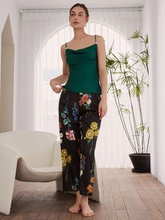 A vintage floral printed pajama set with kimono robe.3pcs: a long robe, a camisole and a long pants.- Black fabric with colorful flowers, contrast green cami and tassel cuffs.- Polyester Charmeuse, silky comfort, machine wash cold.- Removable waist tie closure.- Elastic waistband.- Lapel neckline. - Pearl detailing on straps.- Relaxed fit with a luxurious flowing drape. Black Silk Sets With Floral Print, Elegant Fitted Sets For Night, Elegant Fitted Night Sets, Elegant Night Sets, Elegant Summer Night Sets, Elegant Night Sets For Summer, Elegant Fitted Sleepwear For Pajama Party, Elegant Fitted Loungewear Sets, Spring Sleeveless Night Sets