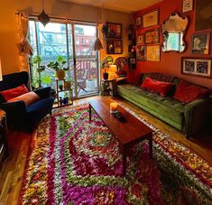 a living room filled with furniture and colorful rugs on top of a hard wood floor