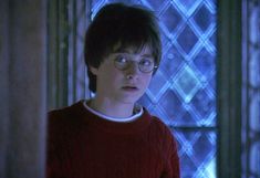 the young harry potter is staring at something