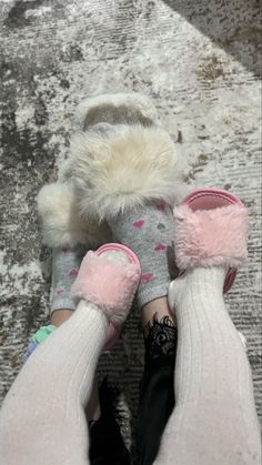 the feet of a person wearing slippers with fuzzy socks and mittens on them