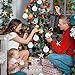 a group of people sitting around a christmas tree