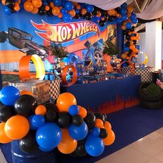 an assortment of balloons and decorations for a hot wheels birthday party