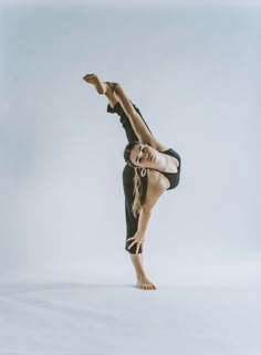 a woman is doing a handstand on one leg