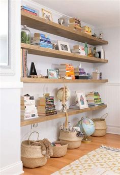 bookshelves and baskets are lined up against the wall