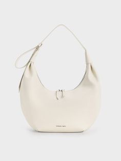 This product is made with at least 20% sustainable materials by weight. CHARLES & KEITH uses recycled, degradable, organic, and water-based materials in our eco-conscious collection. To achieve a city-chic look, style your outfit around the Odella hobo bag. The elegant curves of the crescent exterior exudes sophistication, especially in easy-to-style cream. Tasteful ruching gives the bag a relaxed feel, making it great for casual and dressier occassions alike. With its roomy interior, you will be able to hold all that you need for the day and more -- let the Odella be your new go-to bag. Charles And Keith Bags, Style Your Outfit, Off White Bag, Cream Bags, Bag Obsession, Size Chart For Kids, Charts For Kids, Charles Keith, Printables Kids