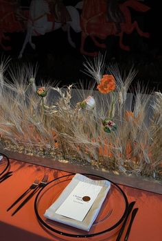 the table is set with silverware and utensils, along with a menu