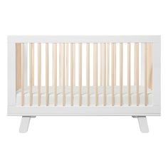 a white crib with wooden slats on the top and bottom legs, in front of a white background