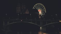 the ferris wheel is lit up at night