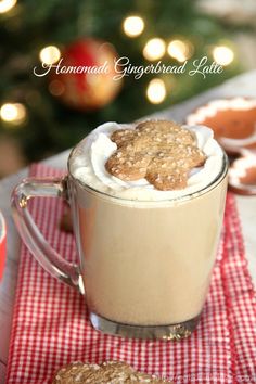 a cup of hot chocolate with marshmallows in it and cookies on the side