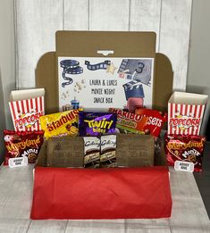 a box filled with candy and snacks sitting on top of a table