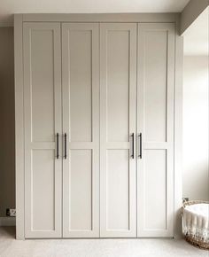 an empty room with white cupboards and carpet