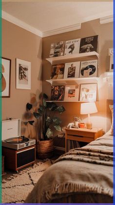 a bed room with a neatly made bed next to a shelf filled with books and pictures