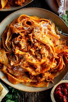 two plates of pasta with meat and sauce