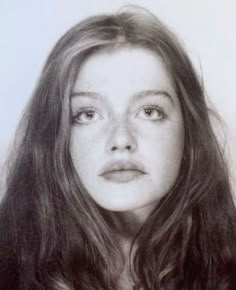 a black and white photo of a woman with long hair