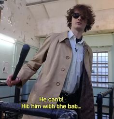 a man in a trench coat holding a baseball bat and wearing sunglasses with the caption he can't hit him with the bat