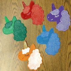 there are five felt animals on the table