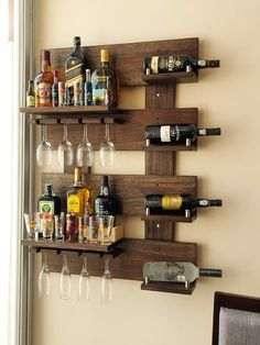 a wall mounted wine rack with bottles and glasses