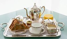 a silver tray topped with breakfast foods and drinks