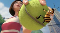 a woman holding a tennis ball with a bee on it's face and another cartoon character in the background