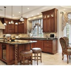 a large kitchen with wooden cabinets and marble counter tops, along with a breakfast nook