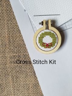 a cross stitch kit with a wooden frame